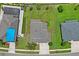 Aerial view of the property showing the roof, backyard, and surrounding neighborhood with lush landscaping at 18558 Cortes Creek Blvd, Spring Hill, FL 34610
