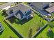 Aerial view of backyard showcasing ample green space, wooden playground, and backyard privacy fence at 18558 Cortes Creek Blvd, Spring Hill, FL 34610