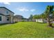 Expansive backyard featuring lush green grass and a secure white fence, perfect for outdoor activities at 18558 Cortes Creek Blvd, Spring Hill, FL 34610