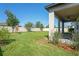 Backyard view highlighting a large grass yard, privacy fence, and exterior patio at 18558 Cortes Creek Blvd, Spring Hill, FL 34610