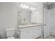 Bathroom featuring double sinks, toilet, and walk-in shower at 18558 Cortes Creek Blvd, Spring Hill, FL 34610