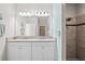 Bright bathroom featuring a double vanity with granite countertops and tiled shower at 18558 Cortes Creek Blvd, Spring Hill, FL 34610