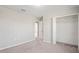 Bright bedroom featuring neutral walls, carpeted floor, and a spacious walk-in closet with ample storage at 18558 Cortes Creek Blvd, Spring Hill, FL 34610