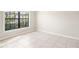 Bright bedroom featuring tile flooring and a window that illuminates the room with natural light at 18558 Cortes Creek Blvd, Spring Hill, FL 34610