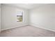 Carpeted bedroom with a large window and natural light at 18558 Cortes Creek Blvd, Spring Hill, FL 34610