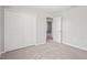 A carpeted bedroom features a closet and neutral walls at 18558 Cortes Creek Blvd, Spring Hill, FL 34610