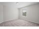 A carpeted bedroom has a window and a ceiling light fixture at 18558 Cortes Creek Blvd, Spring Hill, FL 34610