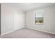 Bedroom featuring a closet, window, and neutral carpet at 18558 Cortes Creek Blvd, Spring Hill, FL 34610