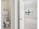 Carpeted bedroom adjacent to a half bath offers plenty of natural light at 18558 Cortes Creek Blvd, Spring Hill, FL 34610