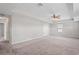 Large bonus room with a ceiling fan and ample space for entertaining or relaxing at 18558 Cortes Creek Blvd, Spring Hill, FL 34610
