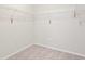 Carpeted walk-in closet featuring white wire shelving and an electrical outlet at 18558 Cortes Creek Blvd, Spring Hill, FL 34610
