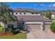 Beautiful two-story home with a well-manicured lawn, a spacious driveway, and a three-car garage at 18558 Cortes Creek Blvd, Spring Hill, FL 34610