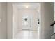 Bright foyer features tile flooring, glass front door, and neutral paint at 18558 Cortes Creek Blvd, Spring Hill, FL 34610
