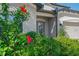 Inviting front entrance framed by lush landscaping, featuring a decorative door and classic exterior lighting at 18558 Cortes Creek Blvd, Spring Hill, FL 34610
