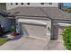 Spacious three-car garage with detailed doors and exterior lighting, offering ample parking and storage at 18558 Cortes Creek Blvd, Spring Hill, FL 34610