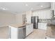 Kitchen featuring a large island with a sink, stainless steel appliances, granite counters, and ample cabinet space at 18558 Cortes Creek Blvd, Spring Hill, FL 34610