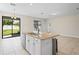 Kitchen island with granite countertop and sink overlooking the backyard through a sliding glass door at 18558 Cortes Creek Blvd, Spring Hill, FL 34610