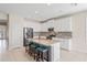 Well-lit kitchen featuring white cabinets, stainless steel appliances, granite countertops, and an island with breakfast bar at 18558 Cortes Creek Blvd, Spring Hill, FL 34610