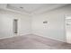 Large main bedroom featuring plush carpeting, neutral walls, a walk-in closet, and an ensuite bathroom at 18558 Cortes Creek Blvd, Spring Hill, FL 34610