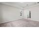 Spacious main bedroom with neutral walls, plush carpeting, a tray ceiling, and an ensuite bathroom at 18558 Cortes Creek Blvd, Spring Hill, FL 34610