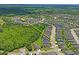 Aerial view of a community featuring a mix of residential properties near natural areas, with access to nearby amenities at 18558 Cortes Creek Blvd, Spring Hill, FL 34610