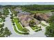 Aerial view of a lovely single-story home with manicured landscaping in a peaceful, wooded neighborhood at 20820 Amanda Oak Ct, Land O Lakes, FL 34638