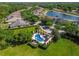 Community pool with manicured landscape and a nearby pond at 20820 Amanda Oak Ct, Land O Lakes, FL 34638