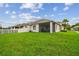 Expansive backyard view highlighting the patio, lush lawn, and home's architecture at 20820 Amanda Oak Ct, Land O Lakes, FL 34638