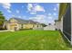 Spacious backyard view with lush lawn, white fence, and home's exterior for outdoor enjoyment at 20820 Amanda Oak Ct, Land O Lakes, FL 34638