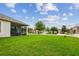 Wide backyard view, highlighting the patio, the lush lawn, and neighborhood homes at 20820 Amanda Oak Ct, Land O Lakes, FL 34638