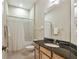 Bathroom with granite vanity, single sink, and shower-tub combo at 20820 Amanda Oak Ct, Land O Lakes, FL 34638