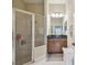 Bathroom boasts glass shower, granite countertop vanity, and bright lighting at 20820 Amanda Oak Ct, Land O Lakes, FL 34638