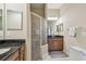 Bright bathroom with dual sinks, granite countertops and glass walk-in shower at 20820 Amanda Oak Ct, Land O Lakes, FL 34638