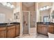 Bright bathroom with dual sinks, granite countertops and glass walk-in shower at 20820 Amanda Oak Ct, Land O Lakes, FL 34638