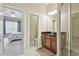 Bathroom with dual sinks, granite countertops and glass walk-in shower at 20820 Amanda Oak Ct, Land O Lakes, FL 34638