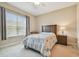 Cozy bedroom features natural light from a large window and neutral-toned walls at 20820 Amanda Oak Ct, Land O Lakes, FL 34638
