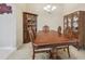 Elegant dining room with a large wooden table and matching china cabinets at 20820 Amanda Oak Ct, Land O Lakes, FL 34638