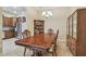 Dining room featuring a large wooden table, chandelier, and view of the kitchen at 20820 Amanda Oak Ct, Land O Lakes, FL 34638