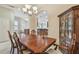 Dining room with large wood table set, china cabinet, and easy access to living spaces at 20820 Amanda Oak Ct, Land O Lakes, FL 34638