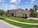 Charming single-story home with a stone-accented facade, well-kept lawn, and tropical landscaping at 20820 Amanda Oak Ct, Land O Lakes, FL 34638