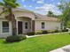 Attractive single-story home with a welcoming entrance framed by stone accents and lush landscaping at 20820 Amanda Oak Ct, Land O Lakes, FL 34638