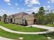 Inviting single-story home featuring a two-car garage, stone accents, and well-maintained landscaping at 20820 Amanda Oak Ct, Land O Lakes, FL 34638