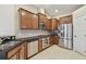 Modern kitchen with stainless steel appliances, dark countertops and brown cabinets at 20820 Amanda Oak Ct, Land O Lakes, FL 34638