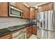 Modern kitchen featuring stainless steel appliances and dark granite countertops at 20820 Amanda Oak Ct, Land O Lakes, FL 34638
