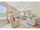 Bright living room with plush seating, neutral tones, and sliding door access to outdoors at 20820 Amanda Oak Ct, Land O Lakes, FL 34638
