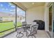 Comfortable screened patio with seating area, view of the yard and neighboring home at 20820 Amanda Oak Ct, Land O Lakes, FL 34638