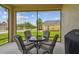 Comfortable screened patio seating area offering outdoor relaxation with a clear neighborhood view at 20820 Amanda Oak Ct, Land O Lakes, FL 34638