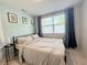 Comfortable bedroom with neutral decor, large window, and ample natural light at 2141 Holiday Dr, Holiday, FL 34691
