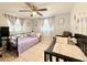 Charming bedroom featuring twin beds, neutral walls, tile floors and a ceiling fan at 2141 Holiday Dr, Holiday, FL 34691