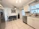Bright kitchen with stainless steel appliances, granite countertops, and adjacent dining area at 2141 Holiday Dr, Holiday, FL 34691